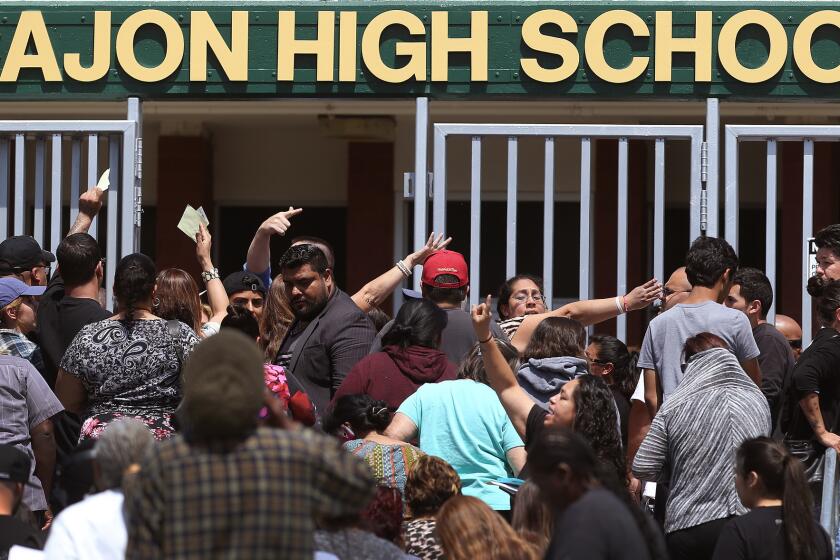 Parents wait to be reunited with their children at Cajon High School after a school shooting at North Park Elementary School.