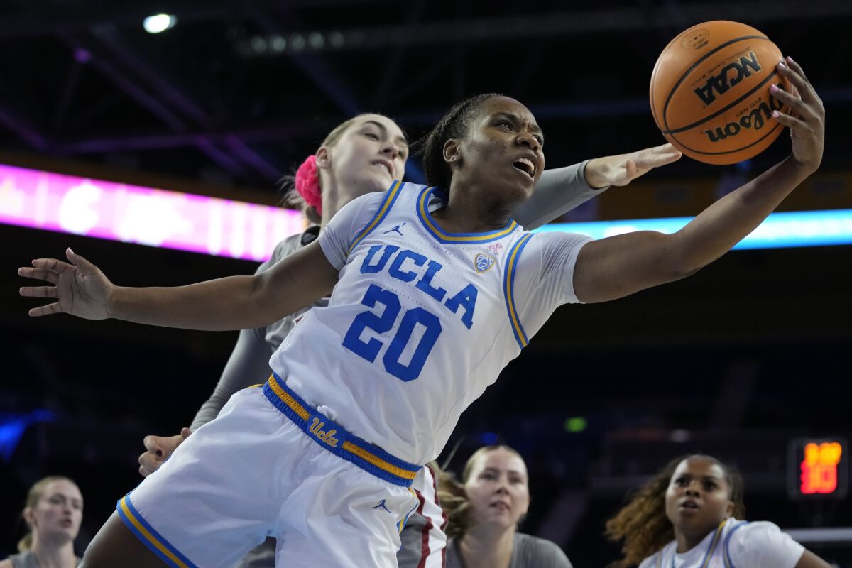 UCLA guard Charisma Osborne grabs a rebound from Washington State center Emma Nankervis.
