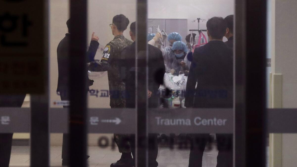 A South Korean soldier, second from left, is seen as medical members treat an unidentified injured person, believed to be a North Korean soldier, at a hospital in Suwon, South Korea, on Nov. 13, 2017.