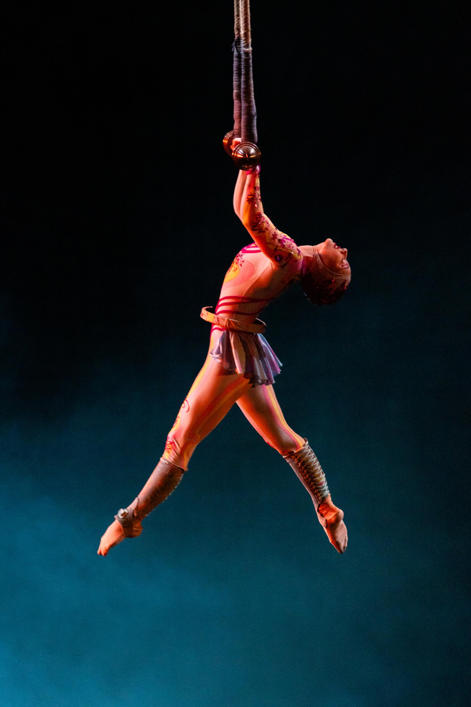 A trapeze artist performs in the air during Cirque du Soleil's "O."