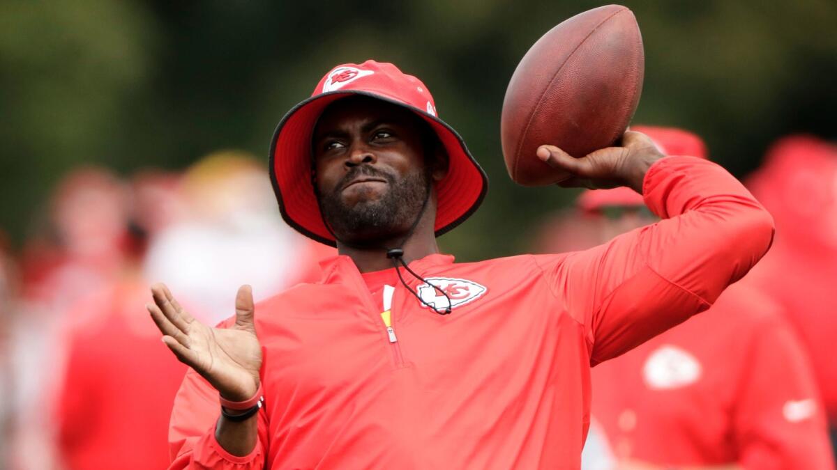 Michael Vick throws a football during a Kansas City Chiefs practice on Aug. 7.