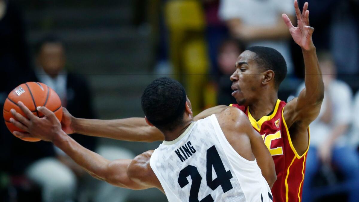 USC guard De'Anthony Melton deflects a pass by Colorado guard George King during the second half Sunday.