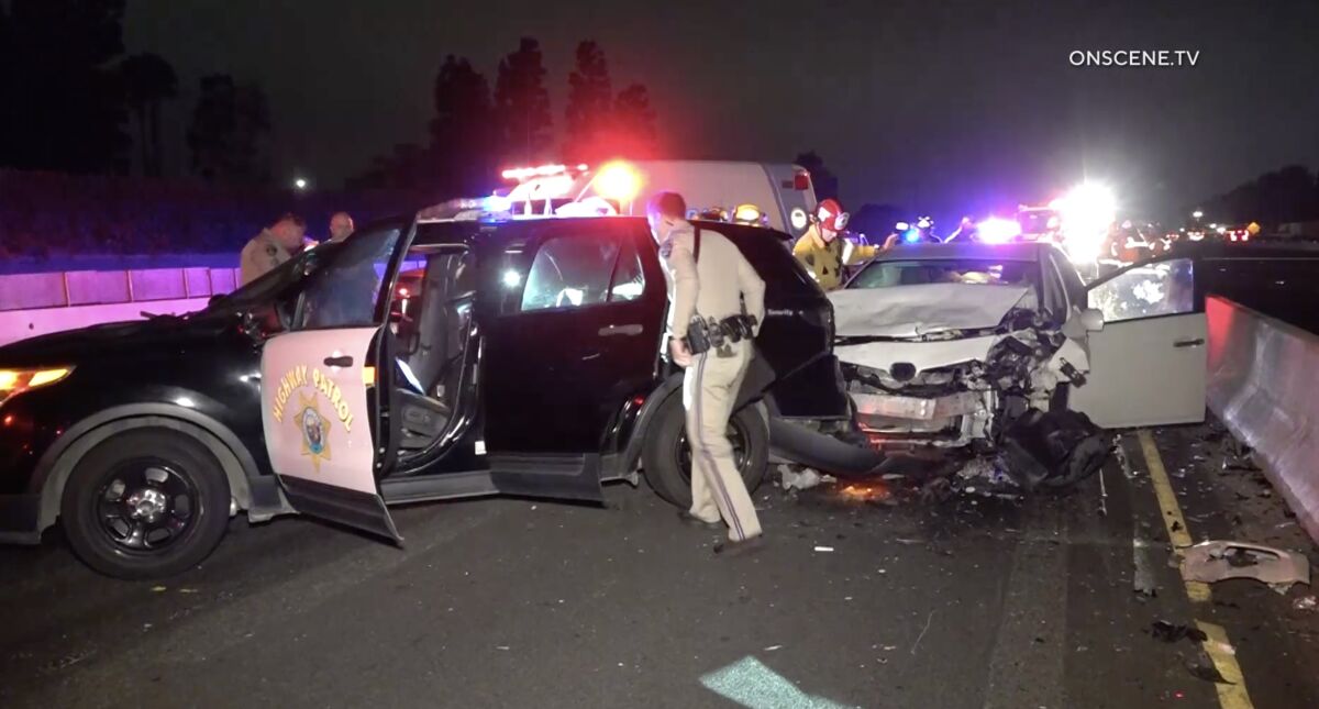 Two CHP officers were injured Friday morning when a car crashed into their cruiser on the southbound 405 Freeway in Fountain Valley.
