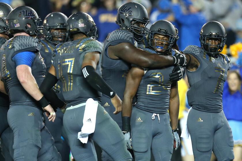 UCLA running back Paul Perkins (24) and the rest of the Bruins wore uniforms with numbers that look like the foil wrapping from a frozen TV dinner last week against Arizona.