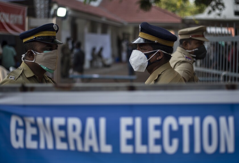 Indian policemen guard at a vote counting center for the state legislature elections amid a weekend lockdown to curb the spread of coronavirus Kochi, Kerala state, India, Sunday, May 2, 2021. (AP Photo/R S Iyer)
