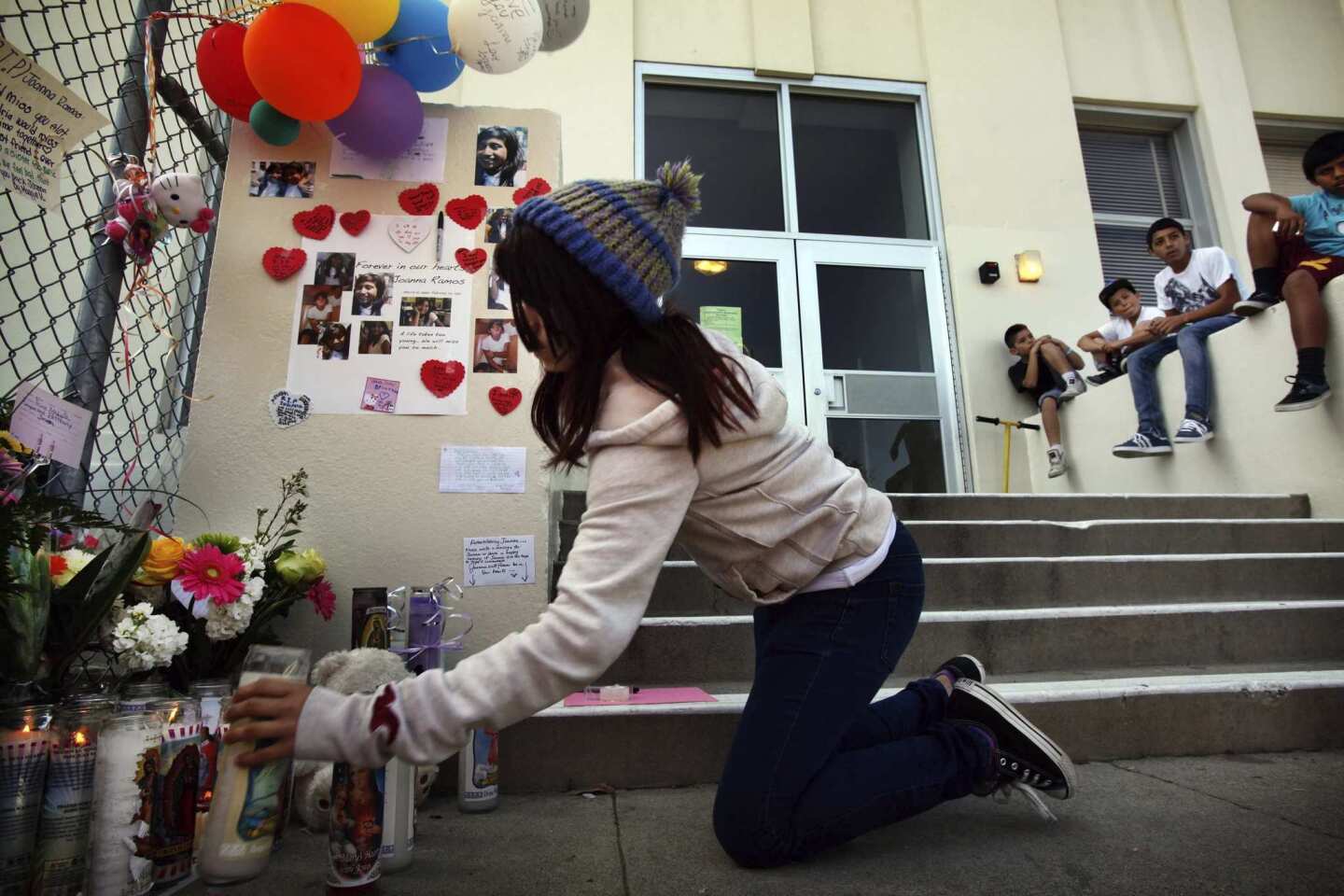 Alexandria Martinez, 12, lights a candle for her best friend Joanna Ramos, 10, who died hours after fighting briefly with another girl.