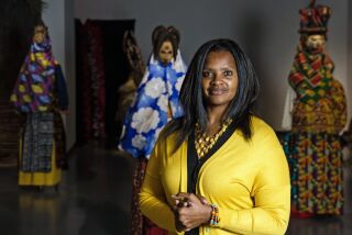 Denise Rogers, a professor of art history, poses at the “Africa in Context” exhibit at San Diego Mesa Colllege on Wednesday, Feb. 1, 2023. Rogers is the curator of the exhibit, which will be on display through Feb. 23.