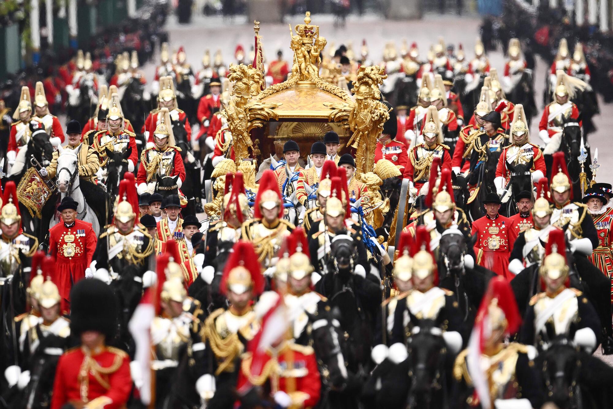 Britain's Queen Camilla and Britain's King Charles III travel back to Buckingham Palace after their coronations.