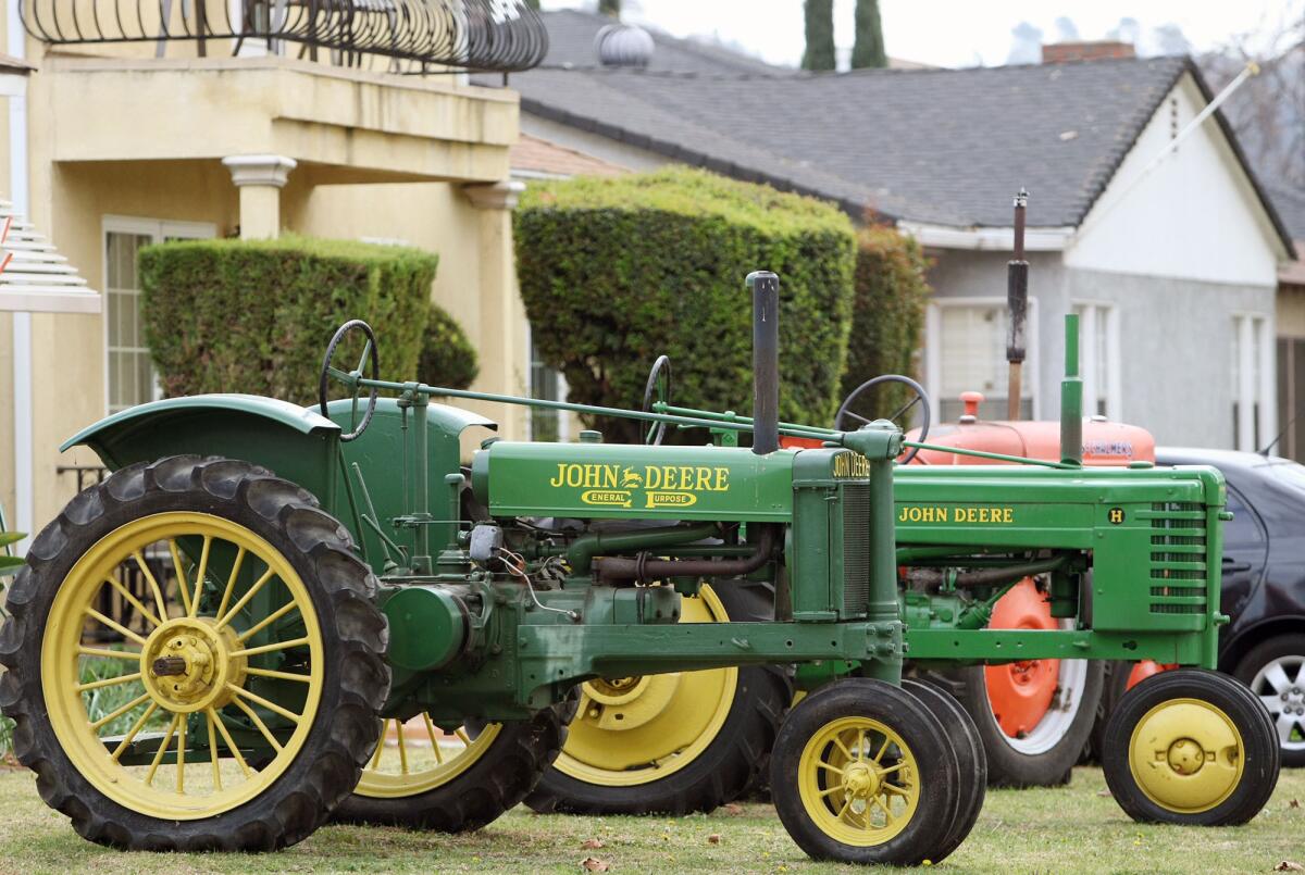 Two John Deere tractors and an Allis-Chalmers tractor are parked in Burbank resident Dan Mustoe's front yard on Mariposa St. for passersby to enjoy.