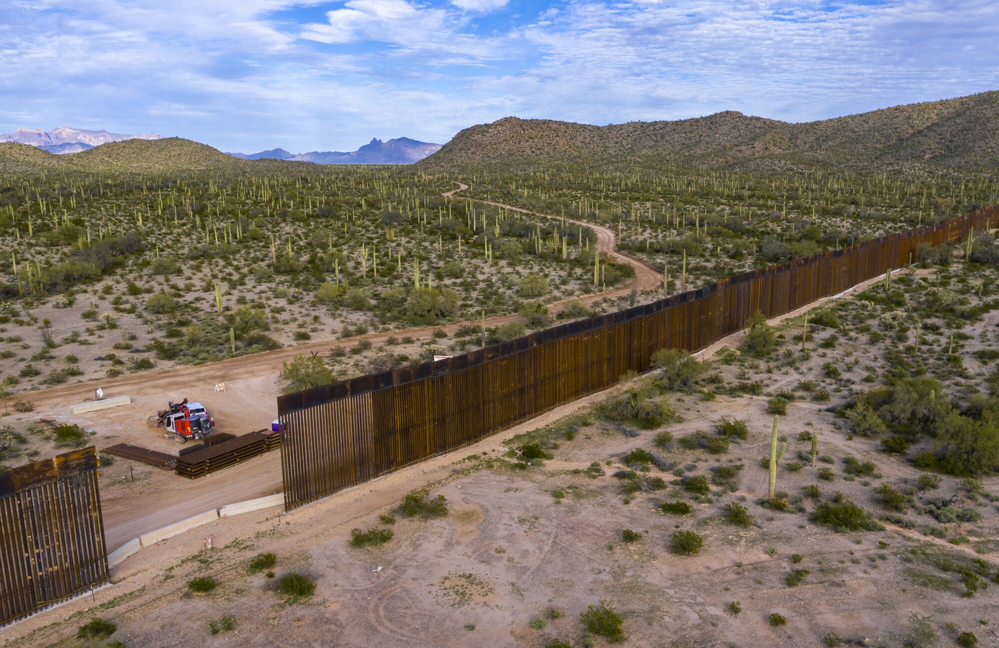Aerial view from the town of Sonoyta, Mexico, of border wall construction west of Lukeville, Ariz. Crews are widening a border road to 60 feet, uprooting cactuses and other plants to make way for a new border wall to replace a vehicle barrier.
