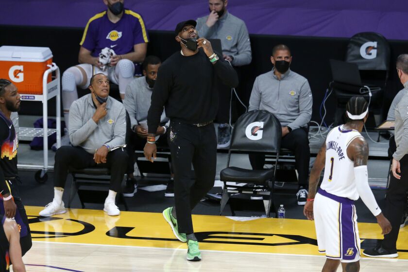 LOS ANGELES, CA - MAY 09: Los Angeles Lakers forward LeBron James (23) watched from the sideline in a game against the Phoenix Suns in the first quarter at the Staples Center on Sunday, May 9, 2021 in Los Angeles, CA. (Gary Coronado / Los Angeles Times)