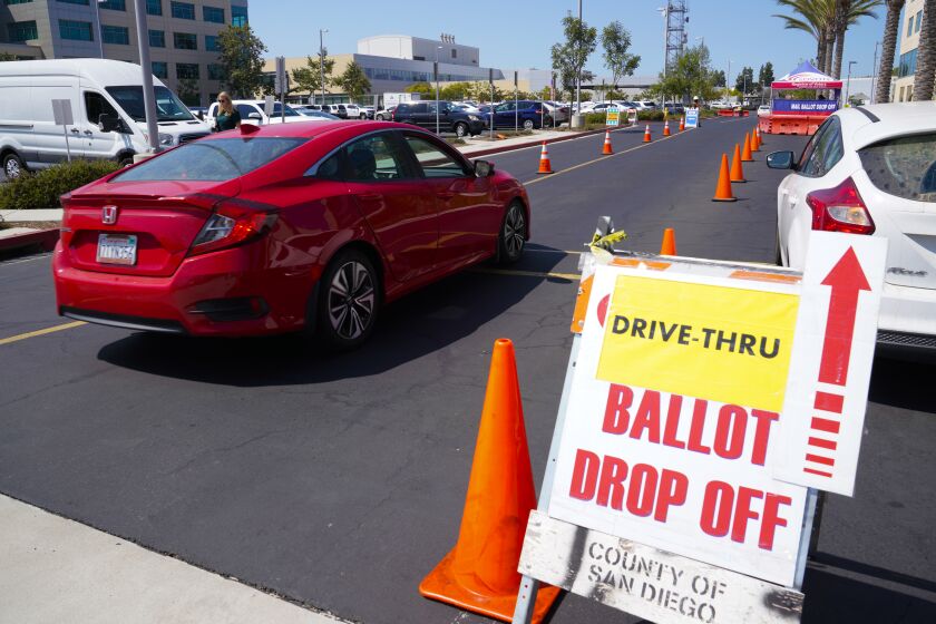 San Diego, CA - September 14: On Tuesday, Sept. 14, 2021 in San Diego, CA., voters wishing to drop of their ballots were direct to one of the drive-thru ballot drop off lanes at the Registrar of Voters office in Kearny Mesa. Voter in California on Tuesday cast their ballot to decide to remove Gov. Gavin Newsom from office and to replace him with one of the 46 candidates running for governor. (Nelvin C. Cepeda / The San Diego Union-Tribune)