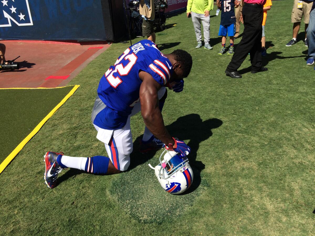 Bills running back Reggie Bush kneels at the Coliseum before Sunday's game against Rams.