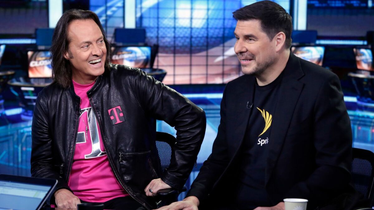 T-Mobile CEO John Legere, left, and Sprint Executive Chairman Marcelo Claure.