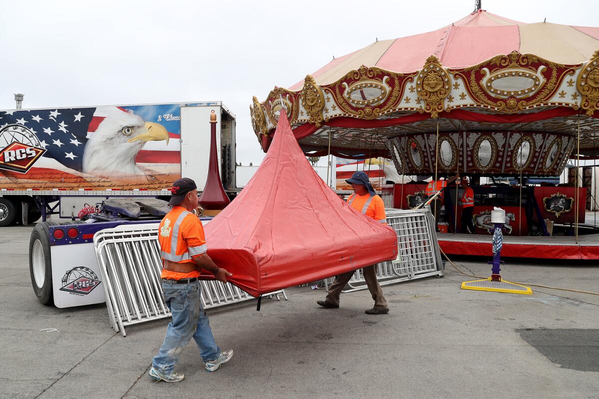 RCS carnival workers set up a carousel Tuesday in preparation for the 2021 O.C. Fair, which runs July 16 through Aug. 15.