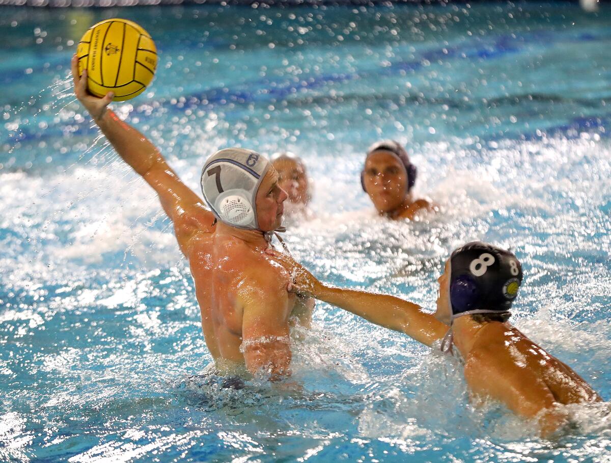CdM's Luke Zimmerman (7) gets a shot off for a goal in the third period during the Battle of the Bay boys' water polo game.