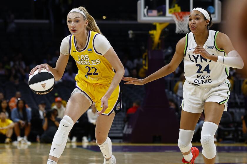 Lakers center Cameron Brink controls the ball in front of te Minnesota Lynx's Napheesa Collier 