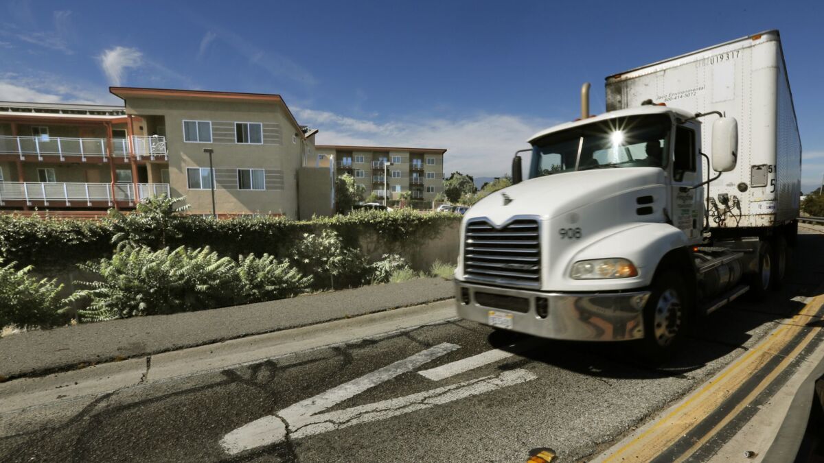 A truck exits the 710 Freeway at East Alondra Boulevard next to an apartment complex in Compton. The U.S. Environmental Protection Agency plans to update emissions standards for heavy-duty diesel trucks in an effort to reduce smog-forming pollution.
