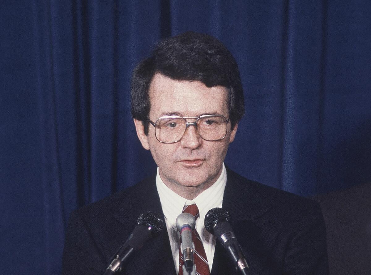 Raymond Donovan, shown in 1980, speaks into microphones.