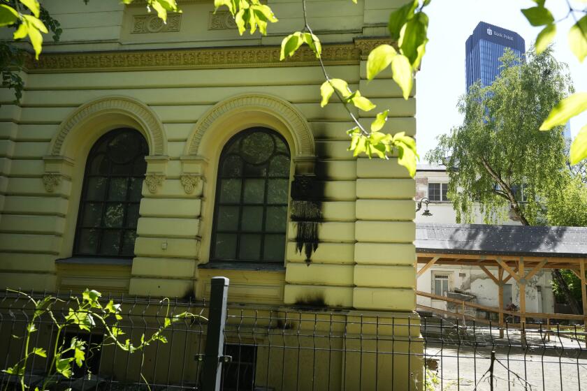 Fire damage is visible on the façade of the Nożyk Synagogue in Warsaw, Poland, on Wednesday, May 1, 2024. The synagogue was attacked with firebombs in the night by an unknown perpetrator, but sustained minimal damage and nobody was hurt. The incident was strongly condemned by political leaders. (AP Photo/Czarek Sokolowski)