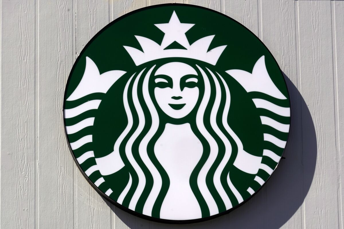 The mermaid logo on a sign outside the Starbucks coffee shop, Monday, March 14, 2022, in Londonderry, N.H. Rossann Williams, Starbucks’ North America president who's been a prominent figure in the company's push against worker unionization, is leaving the company after 17 years. (AP Photo/Charles Krupa)