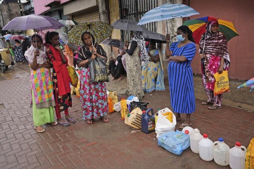 Women wait in a queue to buy kerosene in in Colombo, Sri Lanka, Saturday, June 11, 2022. Sri Lanka's economic crisis, the worst in its history, has completely recast the lives of the country's once galloping middle class. For many families that never had to think twice about fuel or food, the effects have been instant and painful, derailing years of progress toward lifestyles aspired to across South Asia. (AP Photo/Eranga Jayawardena)