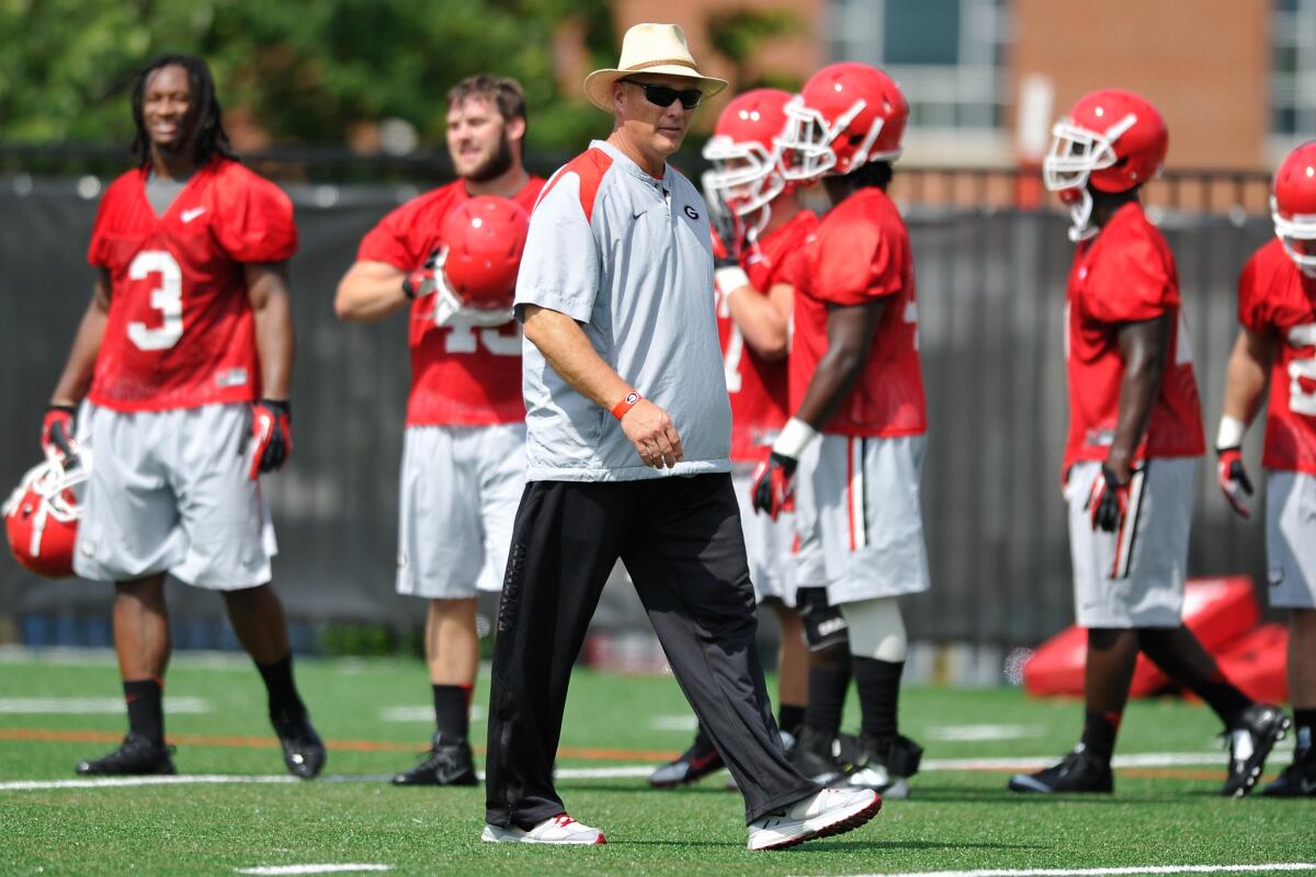 Athens, Ga., may be a hot Labor Day destination this year when the University of Georgia plays Clemson University on Aug. 30. Coach Mark Richt, shown here, watches University of Georgia players at a recent practice.