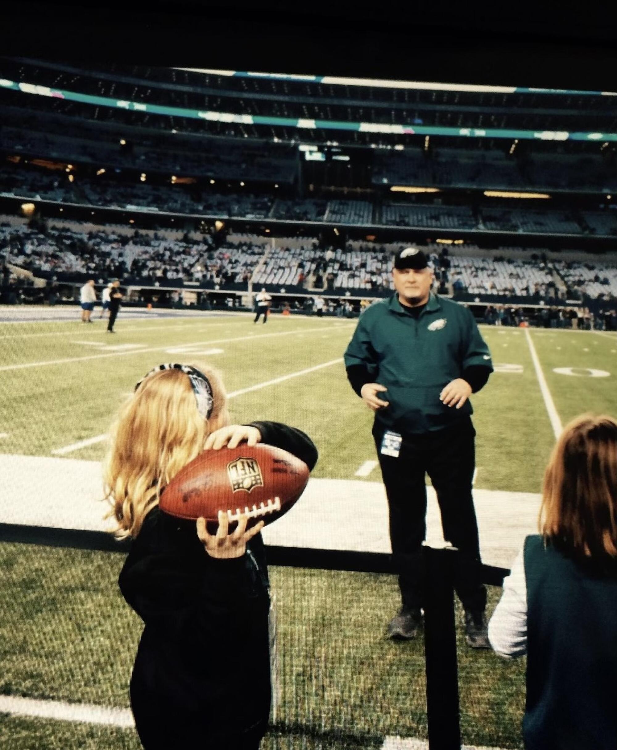 Delainey McGovern throws a pass to her father, Bill McGovern, during his stint as a coach with the Philadelphia Eagles.