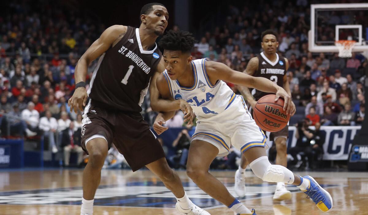 UCLA's Jaylen Hands (4) drives against St. Bonaventure's Idris Taqqee (1) during the first half of a First Four game of the NCAA tournament.