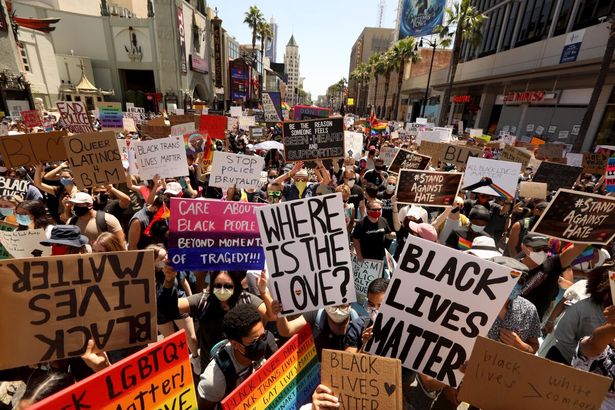 Marchers raise signs as they crowd Hollywood Boulevard during the All Black Lives Matter march