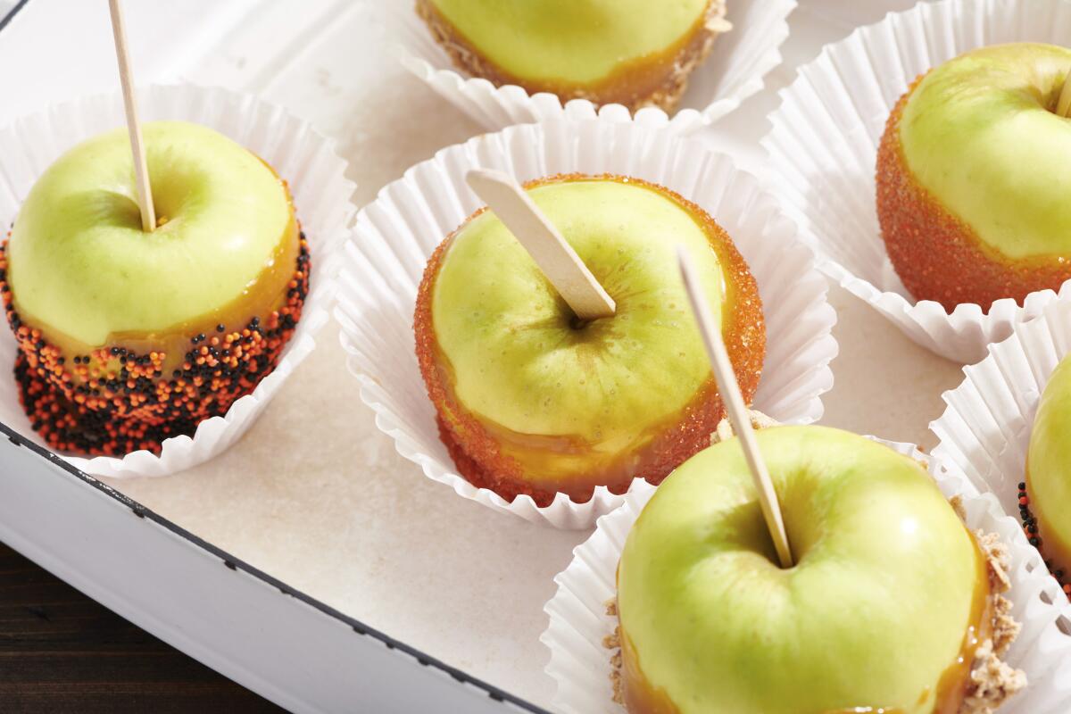 Caramel apples are displayed in a candy store.