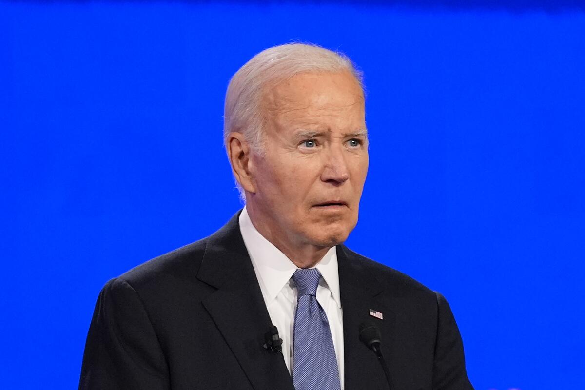 President Biden listens to a question during a presidential debate with former President Donald Trump