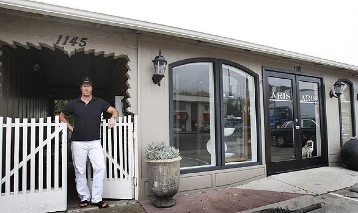 In writing a profile of Laguna Beach retailer Trey Russell, Times Staff Writer Barbara Thornburg found that Russell truly lives what he loves. His second-story garden apartment is right behind his gift shop-boutique Aris, set in a former 1950s Volkswagen dealership in north Laguna Beach on a quiet strip of Pacific Coast Highway.