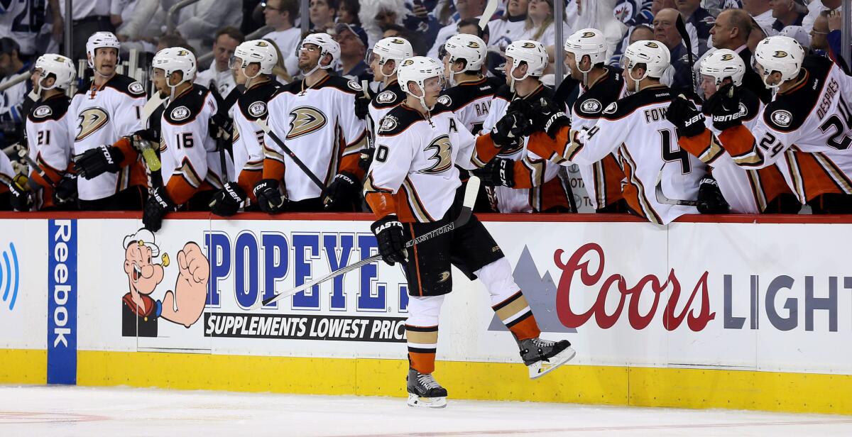 Ducks right wing Corey Perry is congratulated by teammates after scoring against the Jets in the second period of Game 3.