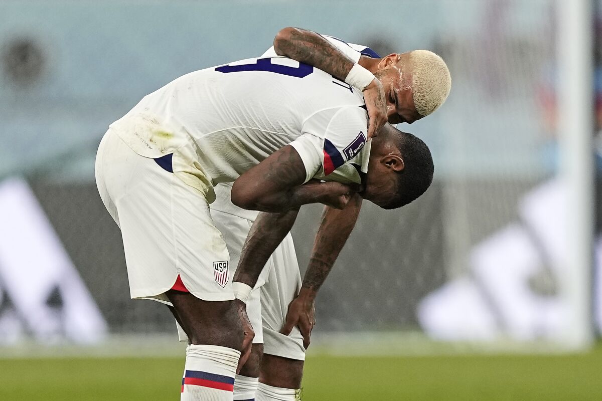 Haji Wright of the United States is comforted after losing in the World Cup Round of 16.