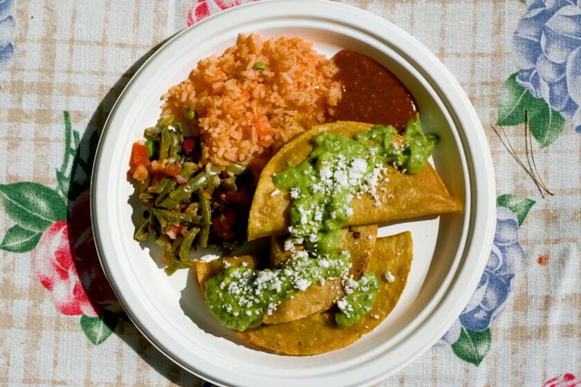 A plate featuring fingerling and raja tacos, rice and sliced poblanos.