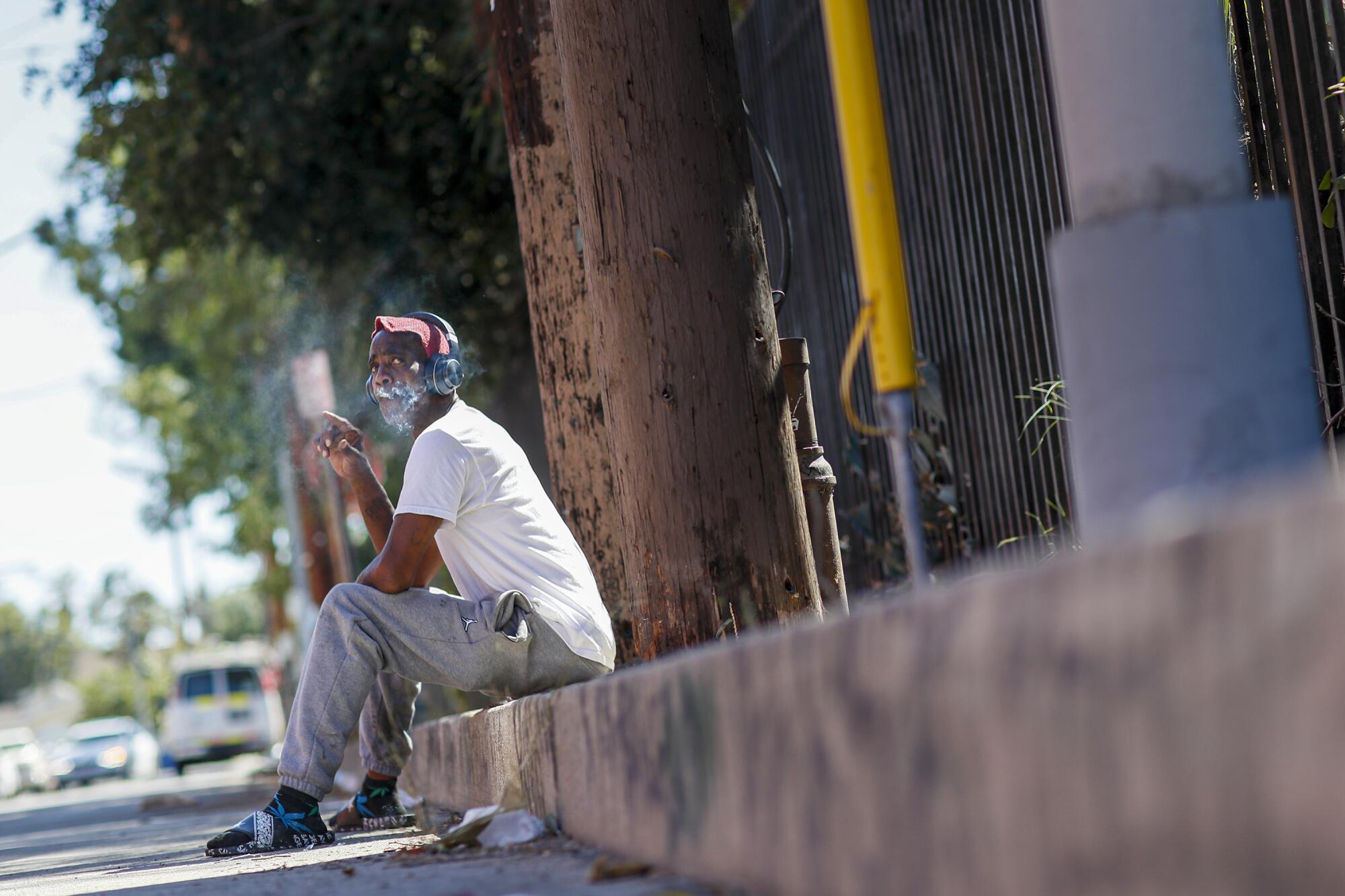 Donald Winston sits alone on a side street minutes after celebrating his birthday at a homeless shelter.
