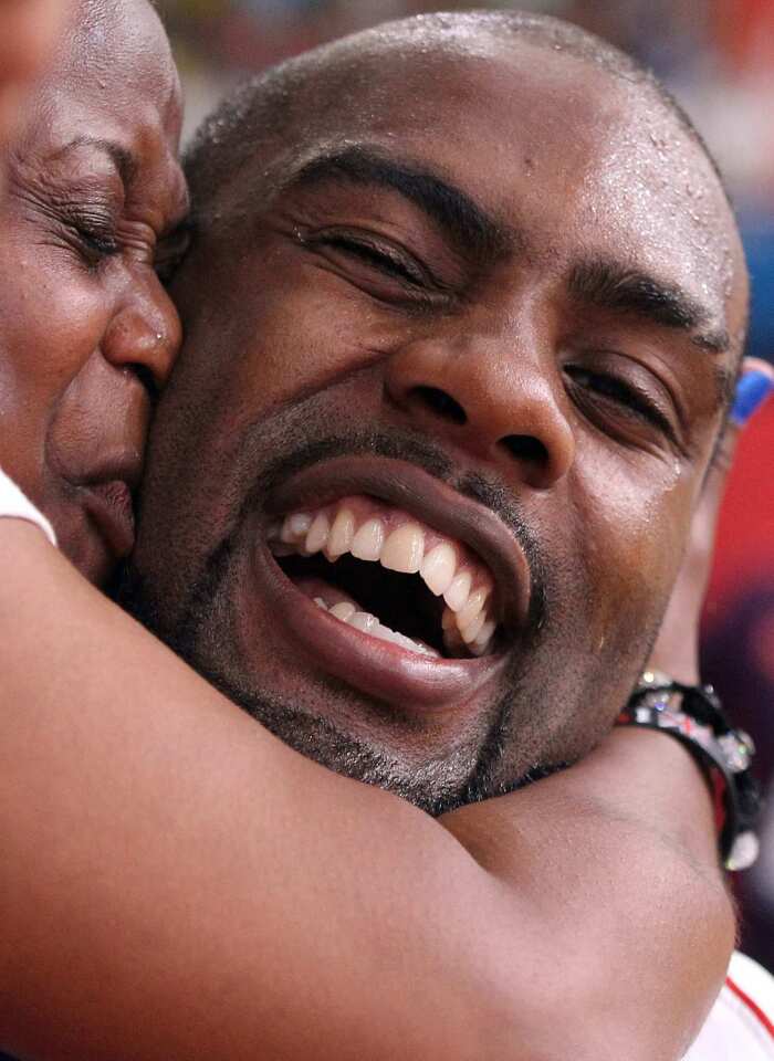 Gold medalist Teddy Riner of France gets a kiss from a family member after winning men's judo final.