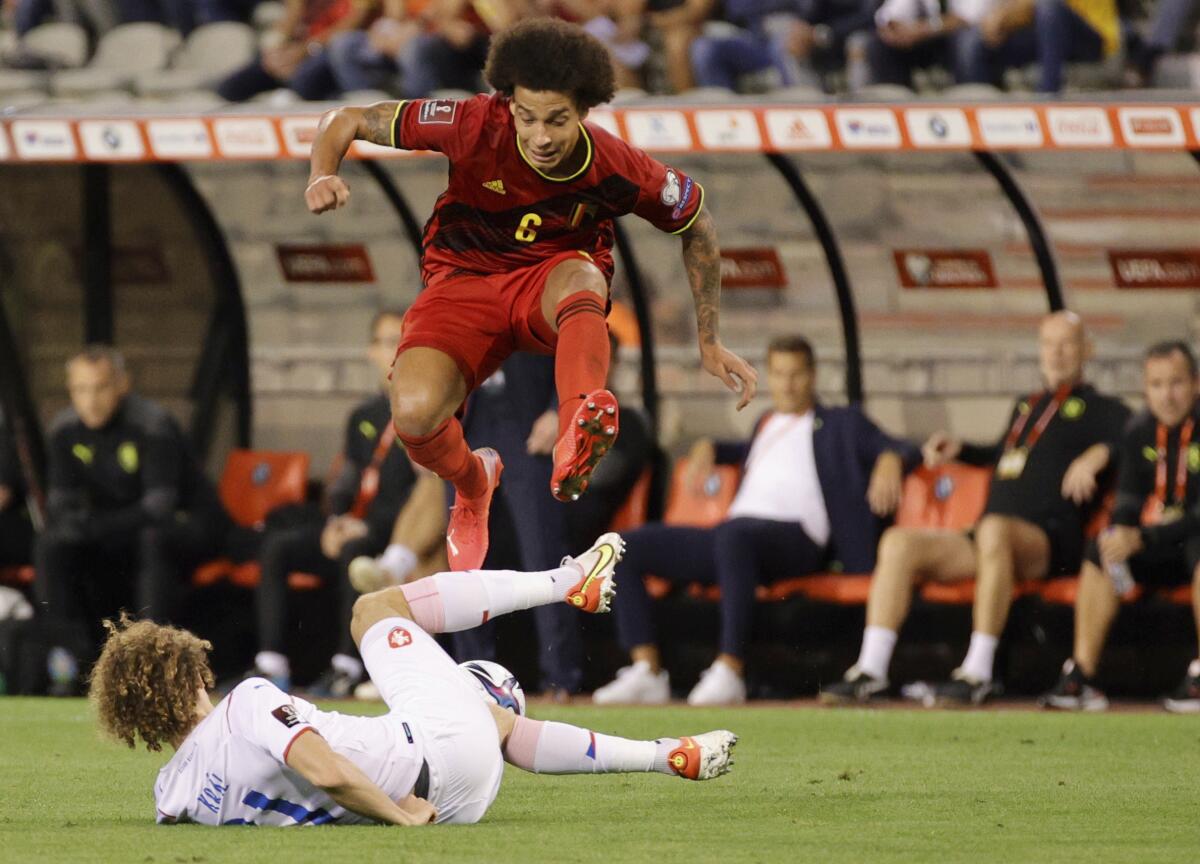 Belgium's Axel Witsel, fights for the ball against Czech Republic's Alex Kral during the World Cup 2022 group E qualifying soccer match between Belgium and the Czech Republic at King Baudouin stadium in Brussels, Sunday, Sept. 5, 2021. (AP Photo/Olivier Matthys)