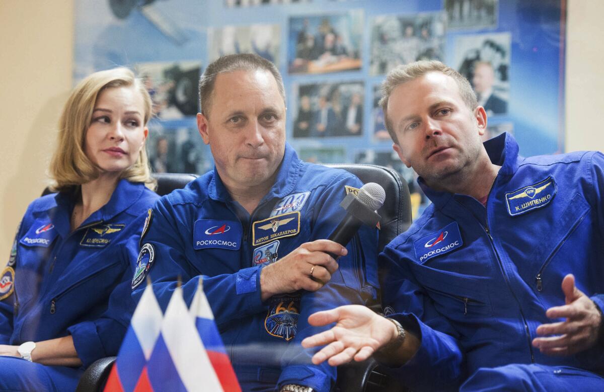 Actress Yulia Peresild, from left, cosmonaut Anton Shkaplerov and director Klim Shipenko