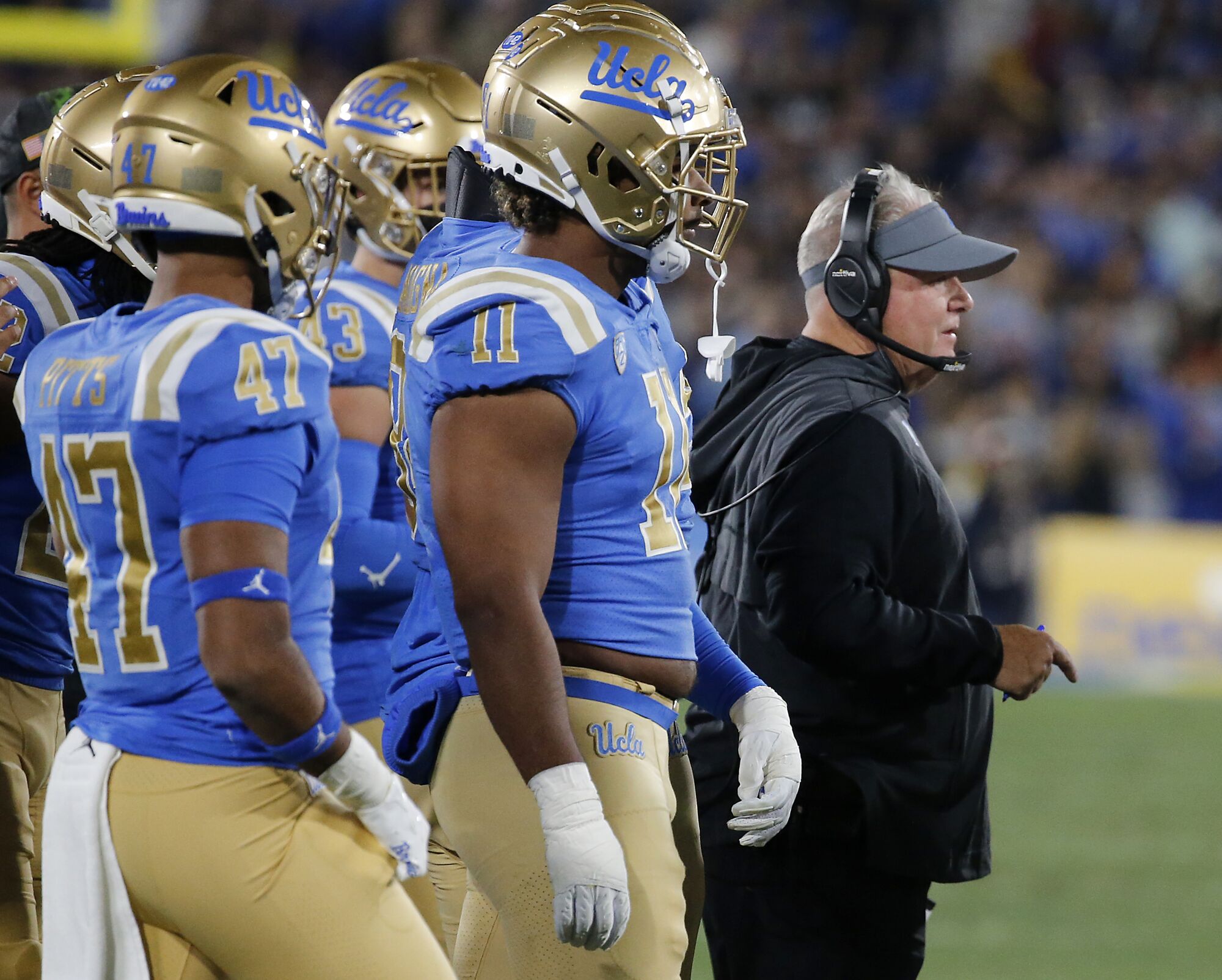 Chip Kelly and other UCLA players on the sideline.
