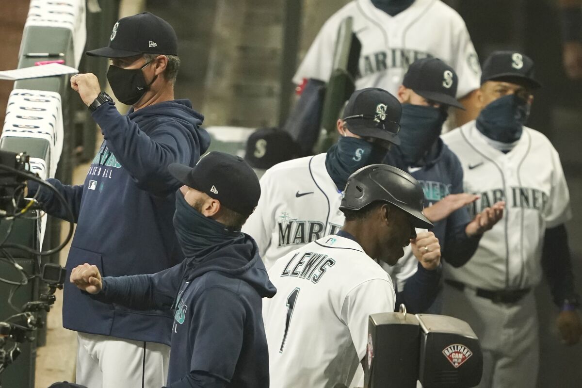 Seattle Mariners' Kyle Lewis (1) is greeted in the dugout after he hit a two-run home run against the Oakland Athletics during the fifth inning of the first baseball game of a doubleheader, Monday, Sept. 14, 2020, in Seattle. (AP Photo/Ted S. Warren)