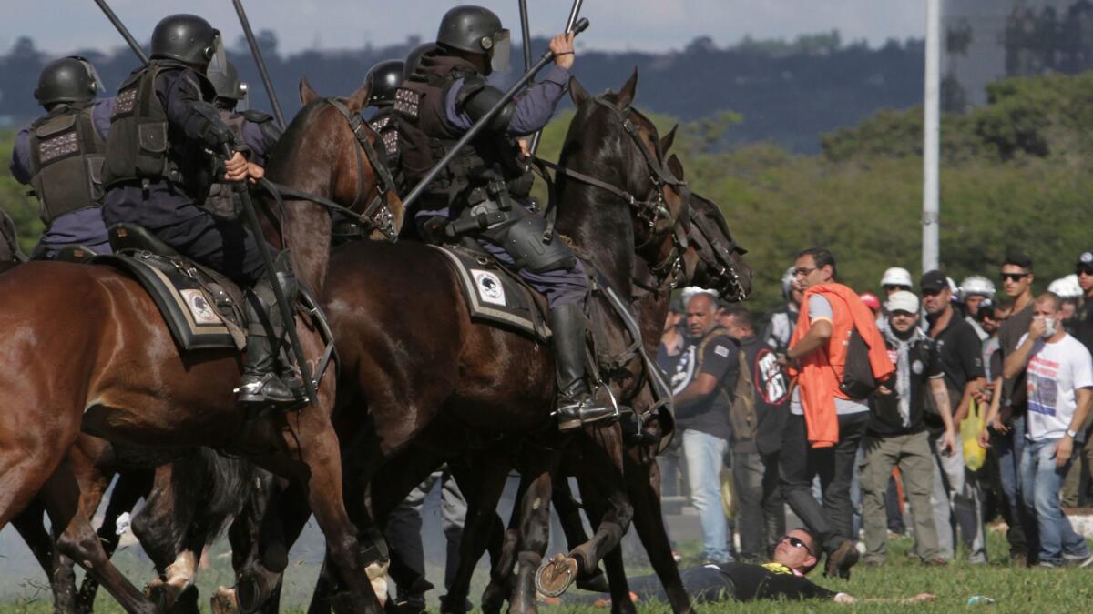 Mounted police charge demonstrators during an antigovernment protest in Brasilia, the Brazilian capital, on Wednesday.