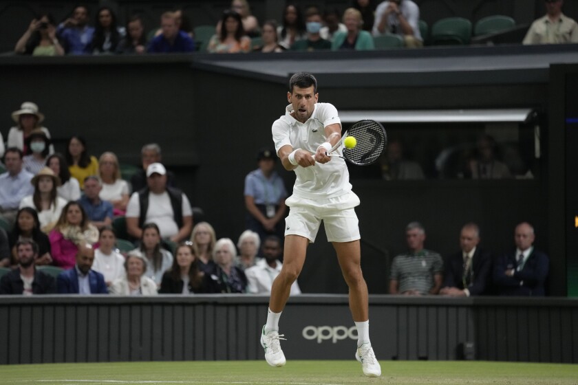 Serbia's Novak Djokovic returns the ball to Tim van Rijthoven of the Netherlands during a men's fourth round singles match on day seven of the Wimbledon tennis championships in London, Sunday, July 3, 2022.(AP Photo/Kirsty Wigglesworth)