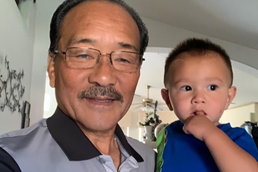 A San Diego advocate for low income workers and racial equality, Robert Ito poses with his grandson.