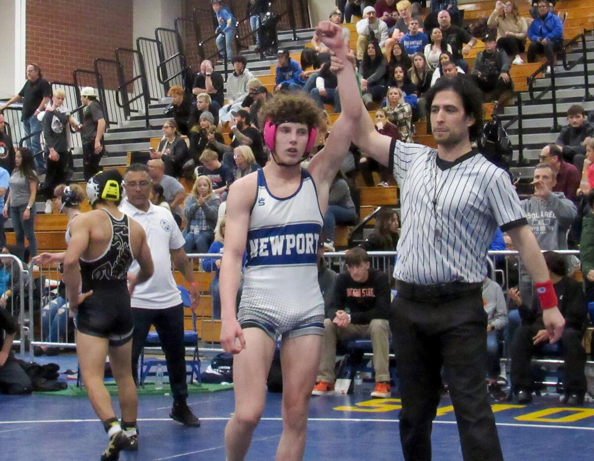 Newport Harbor's Demian Pryima has his arm raised in victory after winning the 132-pound title.