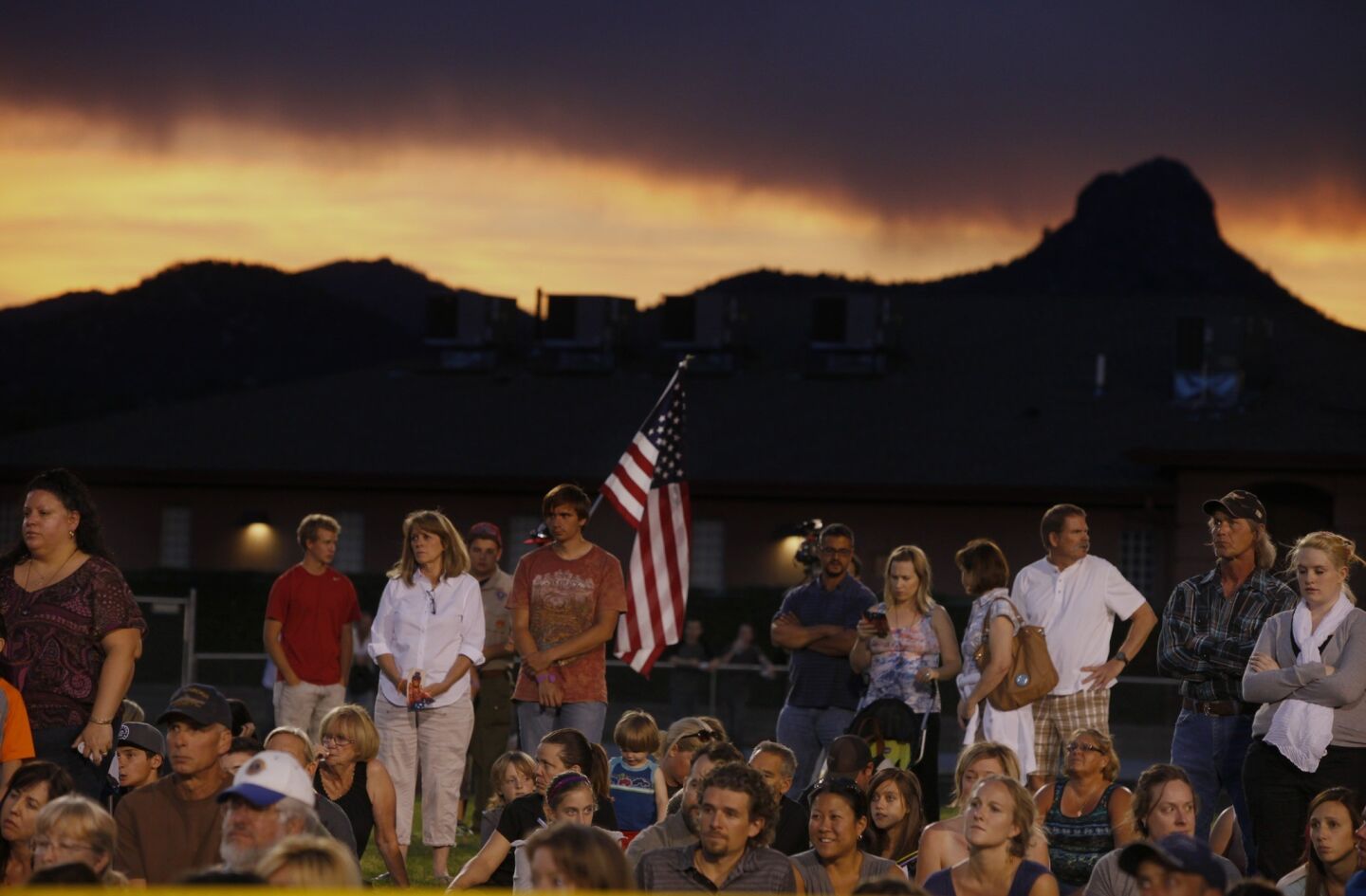 People pay their respects during the vigil at Prescott High School.