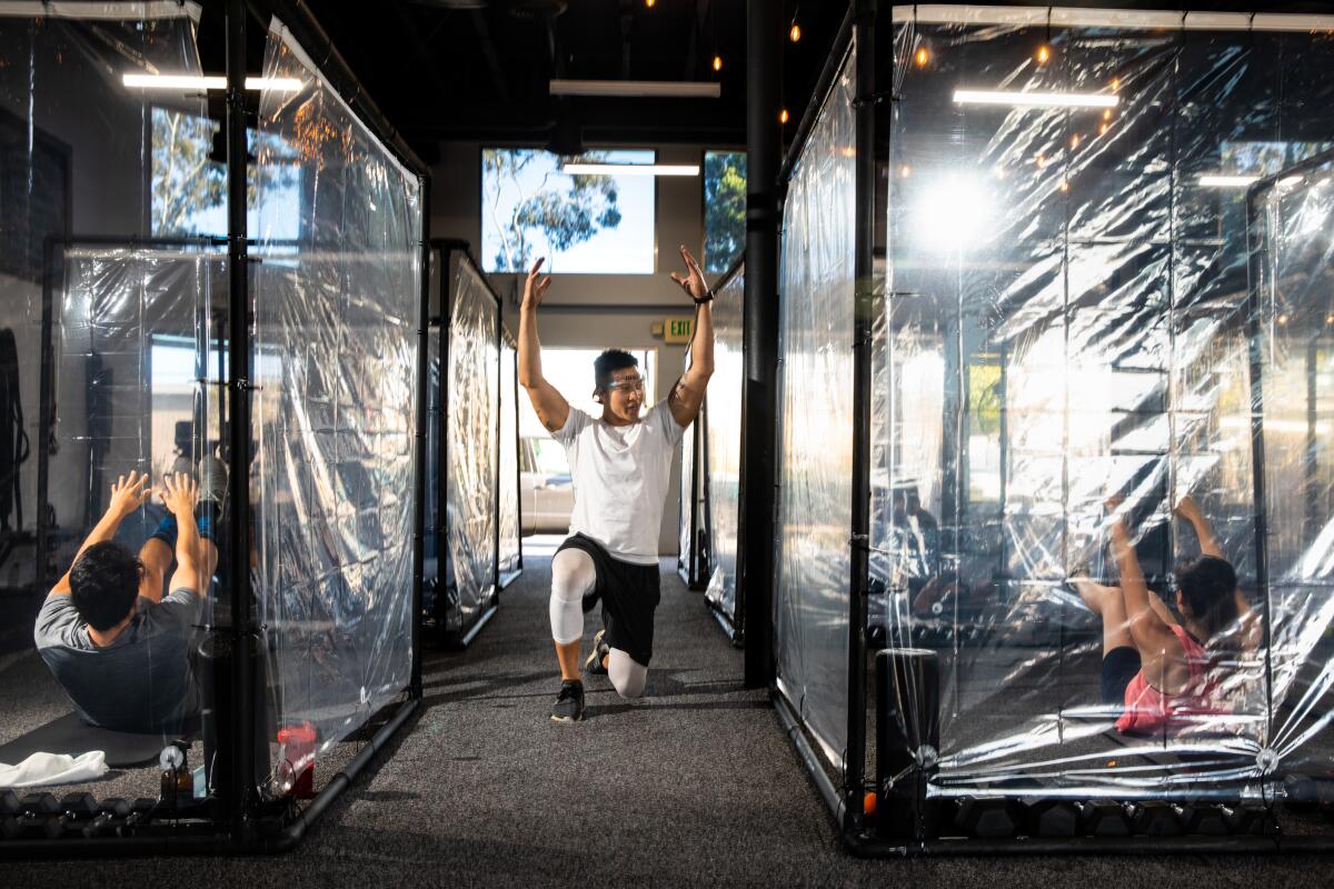 Christian Armenta, left, and Jennie Reynoso work out at Peet Sapsin's Inspire South Bay Fitness in Redondo Beach.