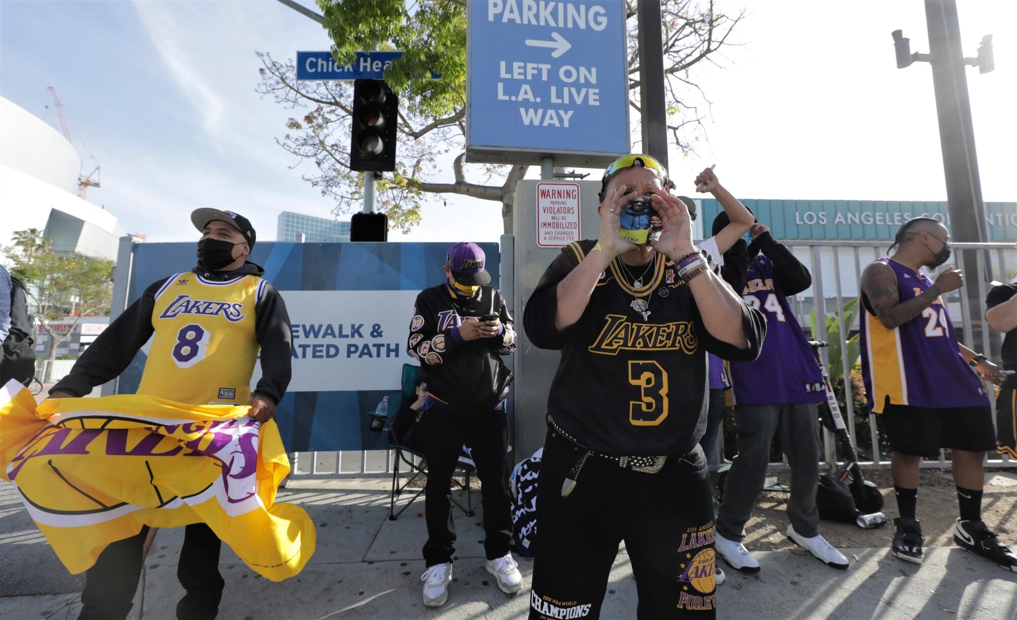 Lakers fan Desiree Engle leads a chant of “Boston sucks” toward some people wearing Celtics jerseys on Thursday.