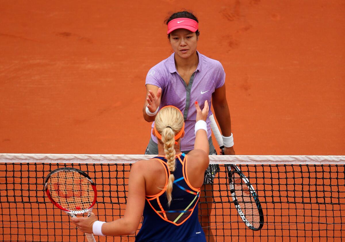 Li Na, top, shakes hands with Kristina Mladenovic after her defeat.